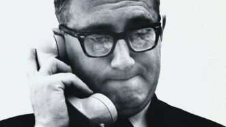 A black and white photo of Henry Kissinger holding a phone to his ear | Photo: Henry Kissinger; Jack Robinson/Condé Nast/Getty