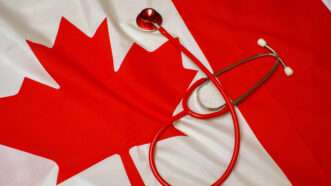 Canadian flag and a stethoscope | Matthew Benoit/Dreamstime