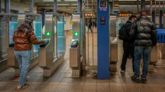 A photo of people people scanning cards at a transit turnstile | Photo: Richard B. Levine/Newscom