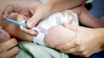 A baby gets an injection in their leg | Robin Utrecht/ANP/Newscom