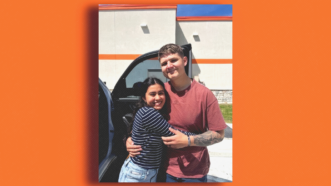 Annie Ramos hugs Matthew Blank as they stand in front of a vehicle with an orange background | Photo courtesy of Annie Ramos and family