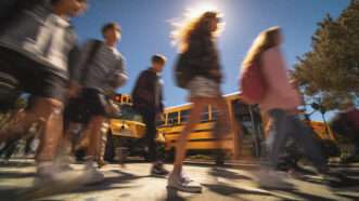 A blurry picture of students in a crosswalk. | Midjourney