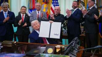 President Donald Trump displays an executive order aimed at facilitating approval of psychedelic therapy | Allison Robbert/Pool via CNP/Zuma Press/Newscom