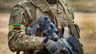 A soldier with a rifle and the flag of Azawad. | Photo: DPST/Newscom