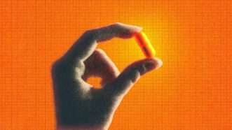 A hand holds a pill against an orange background | Midjourney