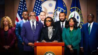 Eight members of the Congressional Black Caucus stand next to each other at a press conference, with chair Rep. Yvette Clark standing at the lectern. | Bill Clark CQ Roll Call/Newscom
