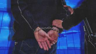 Close-up of a man's handcuffed hands as a police officer leads him away. | Illustration: DPST/Newscom/Roman Milert/Dreamstime