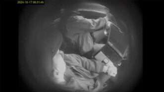 Grainy black-and-white image from an undercover video that caught two Winnipeg police officers stealing. | Manitoba Court of King’s Bench