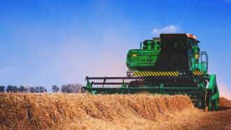 A combine drives through a field | Credit: Dary423/Dreamstime