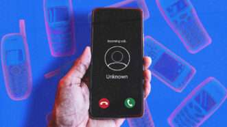 A hand holds a smartphone against a blue background with cellphone outlines | Mohdizzuanbinroslan/Envato/Rthanuthattaphong/Envato