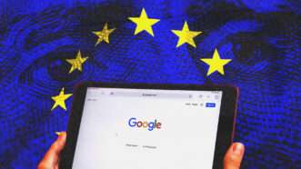A smartphone showing the Google homepage, with the European Union flag in the background | Illustration: Motion5, SteveAllenPhoto999, Africaimages/Envato