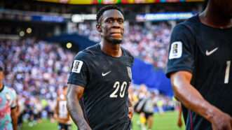 Folarin Balogun walks off the pitch in a navy U.S. soccer jersey, behind a teammate. | Steve Faber/Cal Sport Media/Newscom