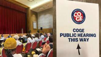 COGE meeting on the left, a sign pointing toward the COGE Public Hearing on the right | Meagan O'Rourke/Reason