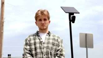 Mason Grimmett stands near an ALPR camera in Wichita | Kansas Justice Institute