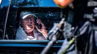 Donald Trump speaking on the phone in a car | Matt Kaminsky/ZUMAPRESS/Newscom