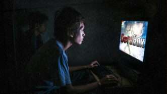 A young man plays Gorebox on a computer. | Illustration: Midjourney/Gorebox/F²Games