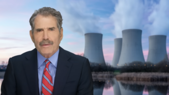 John Stossel is seen in front of a nuclear power plant | Stossel TV