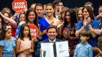 Florida Gov. Ron DeSantis signs the Stop WOKE Act in 2023 surrounded by onlookers. | Daniel A. Varela/TNS/Newscom