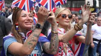 Citizens waving British flags in the street | Teun Voeten/Sipa USA/Newscom