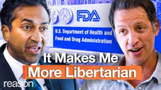 Vinay Prasad appears on the left. Zach Weissmueller appears on the right. An image of the FDA headquarters signage appears behind them. Bold text across the bottom of the screen reads "It Makes Me More Libertarian." | Illustration: Adani Samat