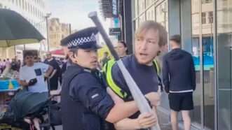 Police in England arrest a man holding a baseball bat. | c5news/Instagram
