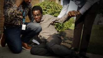 A Haitian national collapses after being fitted with an ankle monitor | Freedomnews.TV/@ScooterCasterNY/X