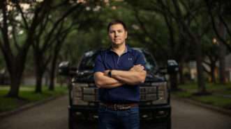 Alek Schott stands on a street in front of a vehicle | Institute for Justice