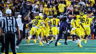 Michigan players in all-maize jerseys storm the field after a winning Hail Mary. | Scott W. Grau/Icon Sportswire CBW/Scott W. Grau/Icon Sportswire/Newscom