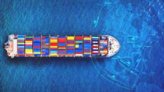 A large boat with shipping containers seen from above | Tawatchai Prakobkit/Dreamstime/Cato Institute