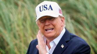 President Donald Trump in a white USA cap | IMAGO/Dan Clohessy/IMAGO/Inpho Photography/Newscom