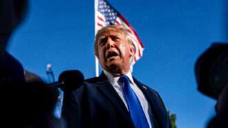 President Donald Trump standing in front of a flag | Bonnie Cash-Pool via CNP/CNP/Polaris/Newscom
