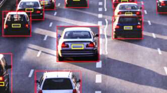 An image of cars driving down a highway, four lanes wide, with red boxes around the cars and yellow boxes around their license plates. | Adani Samat/AltrendoImages/Envato/ChatGPT