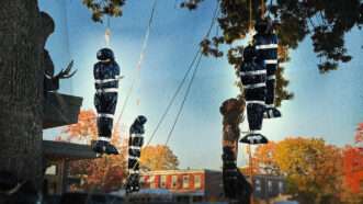 Halloween decorations hang from a tree | Photo: Matthew Harwood