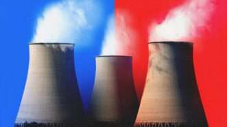 Cooling towers from a nuclear power plant, with a blue and red bisected background | Davidmartyn/Dreamstime/Mariam Zakaidze
