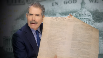 John Stossel holds a copy of the U.S. Constitution | John Stossel