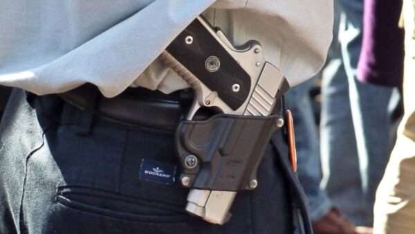 A handgun in a belt holster | Michael Tefft/Flickr