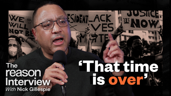 A picture of John McWhorter against a backdrop of protesters holding cardboard signs. The Reason Interview logo is in the bottom left corner and the words "that time is over" are in white and orange | Illustration: Lex Villena