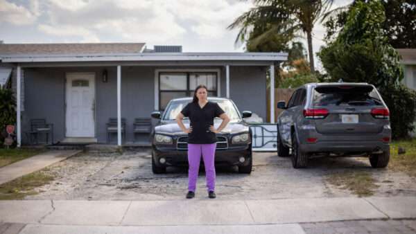 Sandy Martinez stands in front of her home | Institute for Justice