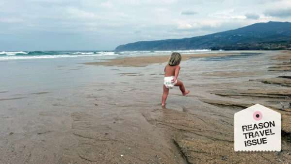 A small child walks along a beach | Photo: Courtesy of Liz Wolfe