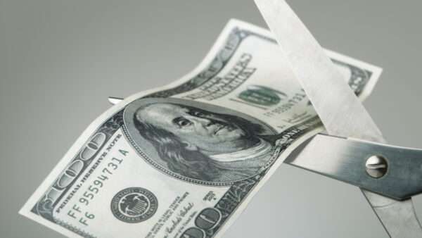 Someone cuts a $100 bill with scissors | ID <a href="https://www.dreamstime.com/stock-images-scissors-cutting-dollar-bill-half-image25167584">25167584</a> ©  <a href="https://www.dreamstime.com/pogonici_info">Pogonici</a> | <a href="https://www.dreamstime.com/">Dreamstime.com</a>
