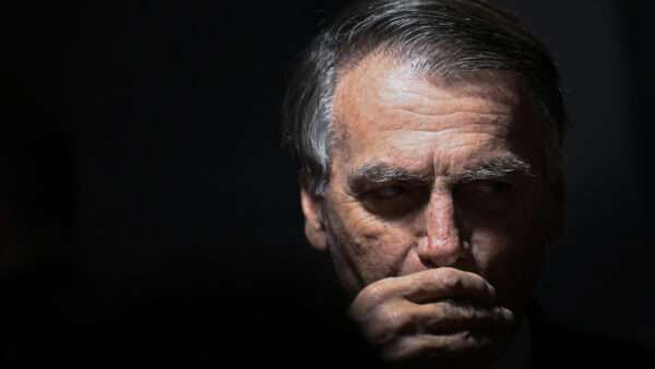 Former Brazilian President Jair Bolsonaro sits before Supreme Court Justice Alexandre de Moraes during his trial. | Mateus Bonomi/AGIF/Sipa USA