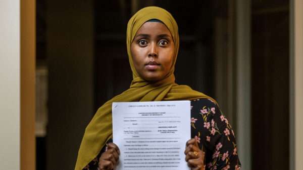 Hamdi Mohamud holding a court document | Photo: Hamdi Mohamud/Institute for Justice