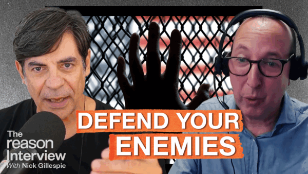 Nick Gillespie speaks into a microphone on the left, and ACLU legal director Ben Wizner appears on the right wearing headphones. Behind them is a dark fence with a hand pressed against it and a blurred American flag in the background. Bold orange text across the center reads “DEFEND YOUR ENEMIES.” | Illustration: Eddie Marshall