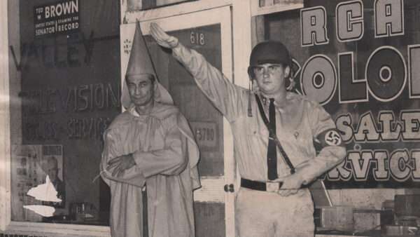 A man in a Klansman hood stands next to a man doing a Nazi salute | Photo: Clarence Brandenburg and Richard Hanna, The Enquirer/Herb Heise via Imagn Content Services LLC