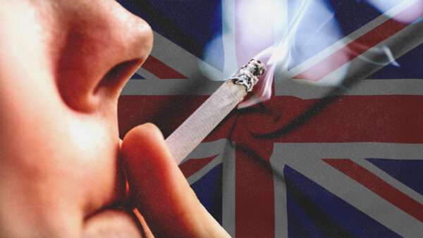 Someone holds a lit cigarette to their lips with the U.K. flag in the background | Envato