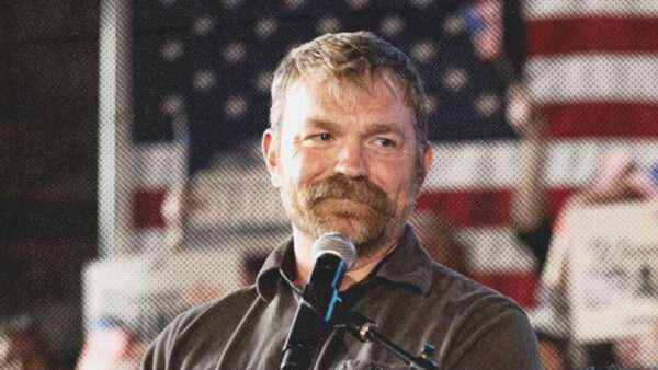 A photo of Graham Platner with an American flag behind him | Graham Platner/Instagram
