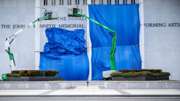 Construction lifts and tarps partially obscuring the Kennedy Center | Photo: Jim Watson/AFP/Getty Images