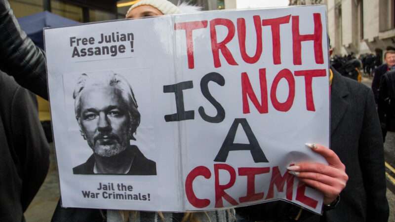 Protester holding sign in support of Julian Assange | Martyn Wheatley/Parsons Media/Zuma Press/Newscom