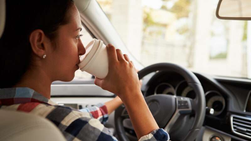 dreamstime_xxl_71528573 | Photo <a href="https://www.dreamstime.com/stock-photo-close-up-hispanic-female-driver-drinking-coffee-car-image71528573">71528573</a> © <a href="https://www.dreamstime.com/monkeybusinessimages_info" itemprop="author">Monkey Business Images</a> - <a href="https://www.dreamstime.com/photos-images/drinking-coffee-car.html">Dreamstime.com</a>