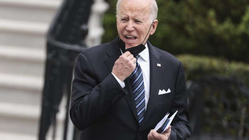 Joe Biden pulling a mask below his face | Oliver Contreras / Ron Sachs/CNP / SplashNews/Newscom